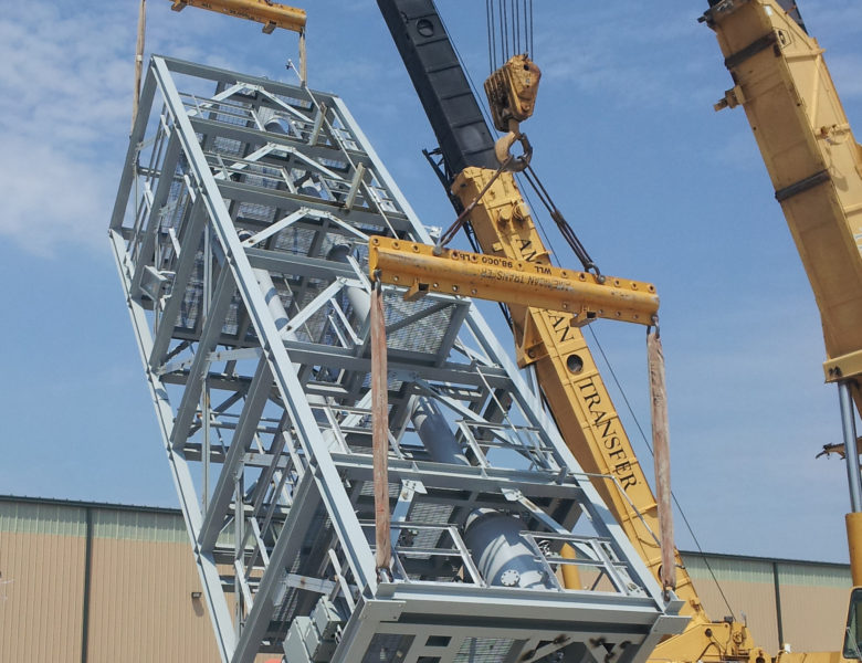 crane holding Process Equipment Modules outside